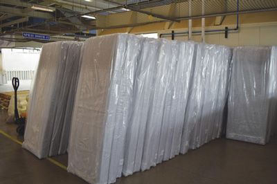 Several mattresses leaning against a wall at IPI's Fort Madison shop